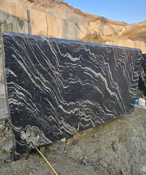 Product Overview: Reliance Titanium Black & Forest Black Granite is a luxurious natural stone celebrated for its striking black background enriched with flowing golden and white veins. Mined from our owned quarry, this granite represents strength, elegance, and timeless beauty — making it a preferred choice for high-end architectural and interior projects across the globe. Each block is a unique creation of nature, offering unmatched character and visual depth. Technical Specifications: Title Reliance Titanium Black & Forest Black Granite Block Stone Type Granite Block Type Gangsaw Block Block Size 300 CM x 180 CM x 180 CM (LXWXH) Color Deep Black with Gold & White Veins Surface Finish Options Wire Saw Cut Density 2960-3000 kg/m3 Compressive Strength 200-250 MPa Water Absorption 0.2%-0.3% Hardness (Mohs) 6 to 7 Porosity Low Origin India Applications Slabs, Countertops, Flooring, Wall Cladding, Interior Key Features: Elegant Aesthetic Appeal: Deep jet-black background enhanced by golden and silver waves — a naturally luxurious look. Superior Strength & Durability: Excellent structural integrity and long-term performance in varied climates. High Polish Retention: Achieves exceptional gloss and mirror-like reflection after finishing. Consistent Texture: Uniform color and grain suitable for large-scale architectural applications. Versatile Application Range: Perfect for multiple interior purposes. Low Maintenance: Resistant to stains, scratches, and moisture, ensuring lasting beauty with minimal upkeep. Export-Grade Blocks: Carefully selected and cut for optimal slab yield and international market standards. Recommended Uses: Kitchen Countertops & Islands Luxury Flooring & Staircases Hotel Lobbies & Reception Areas Wall Cladding & Facades Memorials & Monuments Designer Furniture Tops Why Choose Reliance Titanium Black Granite and Forest Black Granite? Our granite is preferred by export buyers because of: Natural white veins and attractive deep black surface Zero crack, high strength and durability, suitable for projects & reprocessing Consistent Gang Saw block sizes Strict quality checks for each block before shipment Reliable and stable long-term supply Export Capabilities & Payment Terms: We provide smooth, professional export handling with: Payment Options: L/C at sight (Letter of Credit at sight) D/P (Documents Against Payment) T/T advance (if preferred by the buyer) Shipping Documents Provided: Bill of Lading (BL) Commercial Invoice Packing List Certificate of Origin Other documents as per buyer requirements Shipping Price Options: FOB (Indian Port) CNF (any destination port globally) Our logistics team ensures timely loading, documentation, and shipment coordination for a hassle-free experience. About Reliance Mines & Minerals We have a strong presence in the global stone industry, regularly exporting to China, Germany, USA, Oman, and Qatar . Our team is experienced in international trade procedures, ensuring professional communication and smooth cooperation with all partners. We Welcome Your Inquiry If your company is seeking a reliable supplier for premium Titanium black & Forest black granite blocks, we would be pleased to offer quotations, block photos, videos and quarry videos and further details. We look forward to establishing a long-term and successful business relationship with your esteemed company. More About Reliance Titanium Black & Forest Black Granite: Reliance Titanium Black & Forest Black Granite combines natural elegance with engineering excellence. Its bold veins and premium polish bring sophistication to any architectural space, while its robust physical properties ensure durability even in demanding environments. Each block is meticulously extracted and inspected to meet international export quality benchmarks. Reliance Mines & Minerals specializes in the sales and global export of premium granite blocks and slabs. With years of experience in the stone industry, we have established a strong presence in international markets. We are committed to delivering top-quality granite with timely and reliable shipments to major ports worldwide. Our dedicated sales and logistics team is highly skilled in managing export documentation, container loading, and shipping procedures, ensuring a smooth and hassle-free experience for our clients. At the heart of our business is a focus on excellence, professionalism, and customer satisfaction, making us a trusted partner for granite buyers around the globe. 印度 花岗岩 块料 泰坦黑 花岗岩 印度 森林黑 花岗岩 印度 印度 花岗岩 块料, 印度 出口 花岗岩 块, 印度花岗岩原石 中国进口 India granite block Titanium Black granite India Forest Black granite India Granite Blocks Titanium Black Granite Reliance Titanium Black Granite Titanium Black Granite Slabs Polished Titanium Black Granite Bookmatch Titanium Black Granite Titanium Black Granite Exporters India Titanium Black Granite Suppliers Titanium Black Granite Manufacturers Exotic Black Granite with White Veins Deep Black Granite Slabs Mirror Polished Granite Luxury Granite for Interior Walls Natural Stone for Modern Architecture High Gloss Granite Panels Bookmatched Granite Wall Design Black Granite for Hotel Lobby & Flooring Designer Granite Slabs for Projects Indian Granite Exporters Premium Granite from India Granite Slabs for Export Worldwide Granite Supplier Natural Stone Exporter from India Wholesale Granite Supplier Black Granite for Construction & Interiors Architectural Granite Stone Supplier Custom Cut Granite Slabs Export Granite for Wall Cladding Granite for Flooring Granite for Kitchen Countertops Granite for Hotel & Commercial Projects Interior Stone Cladding Luxury Stone for Architects & Designers Black Forest Granite supplier Black Forest Granite manufacturer Black Forest Granite exporter Black Forest Granite quarry Black Forest Granite wholesaler Black Forest Granite seller Buy Black Forest Granite blocks Buy Black Forest Granite slabs Black Forest Granite for flooring Black Forest Granite for countertops Black Forest Granite for wall cladding Black Forest Granite price per sqm Black Forest Granite bulk supplier Black Forest Granite block exporter Black Forest Granite slab manufacturer Black Forest Granite quarry owner Black Forest Granite wholesale price Black Forest Granite large quantity supplier Black Forest Granite custom sizes Black Forest Granite supplier India Black Forest Granite manufacturer India Black Forest Granite exporter India Black Forest Granite quarry India Black Forest Granite supplier [Your City/State] Black Forest Granite international exporter Premium Black Forest Granite supplier Natural Black Forest Granite stone High quality Black Forest Granite slabs Black Forest Granite direct from quarry Black Forest Granite blocks for export Black Forest Granite polished slabs Black granite stone supplier Natural granite stone exporter Indian black granite manufacturer Granite blocks and slabs exporter Dimension stone granite supplier Nebula Wave Granite Stone Manufacturer Export Quality Blocks Supplier Quarry Reliance Mines India Titanium Black Granite Stone Manufacturer Export Quality Blocks Supplier Quarry Reliance Mines India Cosmic Black Granite Stone Manufacturer Export Quality Blocks Supplier Quarry Reliance Mines India Marquina Black Granite Stone Manufacturer Export Quality Blocks Supplier Quarry Reliance Mines India Black Forest Granite Stone Manufacturer Export Quality Blocks Supplier Quarry Reliance Mines India #TitaniumBlackGranite #RelianceGranite #IndianGranite #GraniteExporter #LuxuryGranite #GraniteSupplier #BlackGranite #NaturalStoneIndia #GraniteSlabs #GraniteBookmatch #InteriorDesignStone #ArchitecturalStone #PremiumGranite #GraniteExport #GraniteDesigns #reliancemines #granite #marble #stone #quarry #forestblackgranite