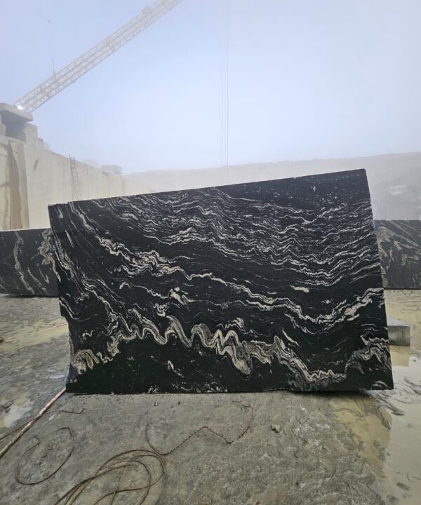 Product Overview: Reliance Titanium Black & Forest Black Granite is a luxurious natural stone celebrated for its striking black background enriched with flowing golden and white veins. Mined from our owned quarry, this granite represents strength, elegance, and timeless beauty — making it a preferred choice for high-end architectural and interior projects across the globe. Each block is a unique creation of nature, offering unmatched character and visual depth. Technical Specifications: Title Reliance Titanium Black & Forest Black Granite Block Stone Type Granite Block Type Gangsaw Block Block Size 300 CM x 180 CM x 180 CM (LXWXH) Color Deep Black with Gold & White Veins Surface Finish Options Wire Saw Cut Density 2960-3000 kg/m3 Compressive Strength 200-250 MPa Water Absorption 0.2%-0.3% Hardness (Mohs) 6 to 7 Porosity Low Origin India Applications Slabs, Countertops, Flooring, Wall Cladding, Interior Key Features: Elegant Aesthetic Appeal: Deep jet-black background enhanced by golden and silver waves — a naturally luxurious look. Superior Strength & Durability: Excellent structural integrity and long-term performance in varied climates. High Polish Retention: Achieves exceptional gloss and mirror-like reflection after finishing. Consistent Texture: Uniform color and grain suitable for large-scale architectural applications. Versatile Application Range: Perfect for multiple interior purposes. Low Maintenance: Resistant to stains, scratches, and moisture, ensuring lasting beauty with minimal upkeep. Export-Grade Blocks: Carefully selected and cut for optimal slab yield and international market standards. Recommended Uses: Kitchen Countertops & Islands Luxury Flooring & Staircases Hotel Lobbies & Reception Areas Wall Cladding & Facades Memorials & Monuments Designer Furniture Tops Why Choose Reliance Titanium Black Granite and Forest Black Granite? Our granite is preferred by export buyers because of: Natural white veins and attractive deep black surface Zero crack, high strength and durability, suitable for projects & reprocessing Consistent Gang Saw block sizes Strict quality checks for each block before shipment Reliable and stable long-term supply Export Capabilities & Payment Terms: We provide smooth, professional export handling with: Payment Options: L/C at sight (Letter of Credit at sight) D/P (Documents Against Payment) T/T advance (if preferred by the buyer) Shipping Documents Provided: Bill of Lading (BL) Commercial Invoice Packing List Certificate of Origin Other documents as per buyer requirements Shipping Price Options: FOB (Indian Port) CNF (any destination port globally) Our logistics team ensures timely loading, documentation, and shipment coordination for a hassle-free experience. About Reliance Mines & Minerals We have a strong presence in the global stone industry, regularly exporting to China, Germany, USA, Oman, and Qatar . Our team is experienced in international trade procedures, ensuring professional communication and smooth cooperation with all partners. We Welcome Your Inquiry If your company is seeking a reliable supplier for premium Titanium black & Forest black granite blocks, we would be pleased to offer quotations, block photos, videos and quarry videos and further details. We look forward to establishing a long-term and successful business relationship with your esteemed company. More About Reliance Titanium Black & Forest Black Granite: Reliance Titanium Black & Forest Black Granite combines natural elegance with engineering excellence. Its bold veins and premium polish bring sophistication to any architectural space, while its robust physical properties ensure durability even in demanding environments. Each block is meticulously extracted and inspected to meet international export quality benchmarks. Reliance Mines & Minerals specializes in the sales and global export of premium granite blocks and slabs. With years of experience in the stone industry, we have established a strong presence in international markets. We are committed to delivering top-quality granite with timely and reliable shipments to major ports worldwide. Our dedicated sales and logistics team is highly skilled in managing export documentation, container loading, and shipping procedures, ensuring a smooth and hassle-free experience for our clients. At the heart of our business is a focus on excellence, professionalism, and customer satisfaction, making us a trusted partner for granite buyers around the globe. 印度 花岗岩 块料 泰坦黑 花岗岩 印度 森林黑 花岗岩 印度 印度 花岗岩 块料, 印度 出口 花岗岩 块, 印度花岗岩原石 中国进口 India granite block Titanium Black granite India Forest Black granite India Granite Blocks Titanium Black Granite Reliance Titanium Black Granite Titanium Black Granite Slabs Polished Titanium Black Granite Bookmatch Titanium Black Granite Titanium Black Granite Exporters India Titanium Black Granite Suppliers Titanium Black Granite Manufacturers Exotic Black Granite with White Veins Deep Black Granite Slabs Mirror Polished Granite Luxury Granite for Interior Walls Natural Stone for Modern Architecture High Gloss Granite Panels Bookmatched Granite Wall Design Black Granite for Hotel Lobby & Flooring Designer Granite Slabs for Projects Indian Granite Exporters Premium Granite from India Granite Slabs for Export Worldwide Granite Supplier Natural Stone Exporter from India Wholesale Granite Supplier Black Granite for Construction & Interiors Architectural Granite Stone Supplier Custom Cut Granite Slabs Export Granite for Wall Cladding Granite for Flooring Granite for Kitchen Countertops Granite for Hotel & Commercial Projects Interior Stone Cladding Luxury Stone for Architects & Designers Black Forest Granite supplier Black Forest Granite manufacturer Black Forest Granite exporter Black Forest Granite quarry Black Forest Granite wholesaler Black Forest Granite seller Buy Black Forest Granite blocks Buy Black Forest Granite slabs Black Forest Granite for flooring Black Forest Granite for countertops Black Forest Granite for wall cladding Black Forest Granite price per sqm Black Forest Granite bulk supplier Black Forest Granite block exporter Black Forest Granite slab manufacturer Black Forest Granite quarry owner Black Forest Granite wholesale price Black Forest Granite large quantity supplier Black Forest Granite custom sizes Black Forest Granite supplier India Black Forest Granite manufacturer India Black Forest Granite exporter India Black Forest Granite quarry India Black Forest Granite supplier [Your City/State] Black Forest Granite international exporter Premium Black Forest Granite supplier Natural Black Forest Granite stone High quality Black Forest Granite slabs Black Forest Granite direct from quarry Black Forest Granite blocks for export Black Forest Granite polished slabs Black granite stone supplier Natural granite stone exporter Indian black granite manufacturer Granite blocks and slabs exporter Dimension stone granite supplier Nebula Wave Granite Stone Manufacturer Export Quality Blocks Supplier Quarry Reliance Mines India Titanium Black Granite Stone Manufacturer Export Quality Blocks Supplier Quarry Reliance Mines India Cosmic Black Granite Stone Manufacturer Export Quality Blocks Supplier Quarry Reliance Mines India Marquina Black Granite Stone Manufacturer Export Quality Blocks Supplier Quarry Reliance Mines India Black Forest Granite Stone Manufacturer Export Quality Blocks Supplier Quarry Reliance Mines India #TitaniumBlackGranite #RelianceGranite #IndianGranite #GraniteExporter #LuxuryGranite #GraniteSupplier #BlackGranite #NaturalStoneIndia #GraniteSlabs #GraniteBookmatch #InteriorDesignStone #ArchitecturalStone #PremiumGranite #GraniteExport #GraniteDesigns #reliancemines #granite #marble #stone #quarry #forestblackgranite