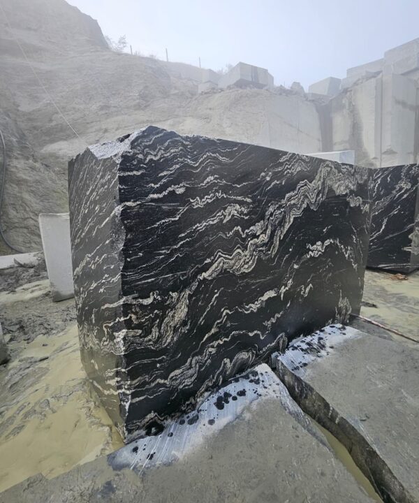 Product Overview: Reliance Titanium Black & Forest Black Granite is a luxurious natural stone celebrated for its striking black background enriched with flowing golden and white veins. Mined from our owned quarry, this granite represents strength, elegance, and timeless beauty — making it a preferred choice for high-end architectural and interior projects across the globe. Each block is a unique creation of nature, offering unmatched character and visual depth. Technical Specifications: Title Reliance Titanium Black & Forest Black Granite Block Stone Type Granite Block Type Gangsaw Block Block Size 300 CM x 180 CM x 180 CM (LXWXH) Color Deep Black with Gold & White Veins Surface Finish Options Wire Saw Cut Density 2960-3000 kg/m3 Compressive Strength 200-250 MPa Water Absorption 0.2%-0.3% Hardness (Mohs) 6 to 7 Porosity Low Origin India Applications Slabs, Countertops, Flooring, Wall Cladding, Interior Key Features: Elegant Aesthetic Appeal: Deep jet-black background enhanced by golden and silver waves — a naturally luxurious look. Superior Strength & Durability: Excellent structural integrity and long-term performance in varied climates. High Polish Retention: Achieves exceptional gloss and mirror-like reflection after finishing. Consistent Texture: Uniform color and grain suitable for large-scale architectural applications. Versatile Application Range: Perfect for multiple interior purposes. Low Maintenance: Resistant to stains, scratches, and moisture, ensuring lasting beauty with minimal upkeep. Export-Grade Blocks: Carefully selected and cut for optimal slab yield and international market standards. Recommended Uses: Kitchen Countertops & Islands Luxury Flooring & Staircases Hotel Lobbies & Reception Areas Wall Cladding & Facades Memorials & Monuments Designer Furniture Tops Why Choose Reliance Titanium Black Granite and Forest Black Granite? Our granite is preferred by export buyers because of: Natural white veins and attractive deep black surface Zero crack, high strength and durability, suitable for projects & reprocessing Consistent Gang Saw block sizes Strict quality checks for each block before shipment Reliable and stable long-term supply Export Capabilities & Payment Terms: We provide smooth, professional export handling with: Payment Options: L/C at sight (Letter of Credit at sight) D/P (Documents Against Payment) T/T advance (if preferred by the buyer) Shipping Documents Provided: Bill of Lading (BL) Commercial Invoice Packing List Certificate of Origin Other documents as per buyer requirements Shipping Price Options: FOB (Indian Port) CNF (any destination port globally) Our logistics team ensures timely loading, documentation, and shipment coordination for a hassle-free experience. About Reliance Mines & Minerals We have a strong presence in the global stone industry, regularly exporting to China, Germany, USA, Oman, and Qatar . Our team is experienced in international trade procedures, ensuring professional communication and smooth cooperation with all partners. We Welcome Your Inquiry If your company is seeking a reliable supplier for premium Titanium black & Forest black granite blocks, we would be pleased to offer quotations, block photos, videos and quarry videos and further details. We look forward to establishing a long-term and successful business relationship with your esteemed company. More About Reliance Titanium Black & Forest Black Granite: Reliance Titanium Black & Forest Black Granite combines natural elegance with engineering excellence. Its bold veins and premium polish bring sophistication to any architectural space, while its robust physical properties ensure durability even in demanding environments. Each block is meticulously extracted and inspected to meet international export quality benchmarks. Reliance Mines & Minerals specializes in the sales and global export of premium granite blocks and slabs. With years of experience in the stone industry, we have established a strong presence in international markets. We are committed to delivering top-quality granite with timely and reliable shipments to major ports worldwide. Our dedicated sales and logistics team is highly skilled in managing export documentation, container loading, and shipping procedures, ensuring a smooth and hassle-free experience for our clients. At the heart of our business is a focus on excellence, professionalism, and customer satisfaction, making us a trusted partner for granite buyers around the globe. 印度 花岗岩 块料 泰坦黑 花岗岩 印度 森林黑 花岗岩 印度 印度 花岗岩 块料, 印度 出口 花岗岩 块, 印度花岗岩原石 中国进口 India granite block Titanium Black granite India Forest Black granite India Granite Blocks Titanium Black Granite Reliance Titanium Black Granite Titanium Black Granite Slabs Polished Titanium Black Granite Bookmatch Titanium Black Granite Titanium Black Granite Exporters India Titanium Black Granite Suppliers Titanium Black Granite Manufacturers Exotic Black Granite with White Veins Deep Black Granite Slabs Mirror Polished Granite Luxury Granite for Interior Walls Natural Stone for Modern Architecture High Gloss Granite Panels Bookmatched Granite Wall Design Black Granite for Hotel Lobby & Flooring Designer Granite Slabs for Projects Indian Granite Exporters Premium Granite from India Granite Slabs for Export Worldwide Granite Supplier Natural Stone Exporter from India Wholesale Granite Supplier Black Granite for Construction & Interiors Architectural Granite Stone Supplier Custom Cut Granite Slabs Export Granite for Wall Cladding Granite for Flooring Granite for Kitchen Countertops Granite for Hotel & Commercial Projects Interior Stone Cladding Luxury Stone for Architects & Designers Black Forest Granite supplier Black Forest Granite manufacturer Black Forest Granite exporter Black Forest Granite quarry Black Forest Granite wholesaler Black Forest Granite seller Buy Black Forest Granite blocks Buy Black Forest Granite slabs Black Forest Granite for flooring Black Forest Granite for countertops Black Forest Granite for wall cladding Black Forest Granite price per sqm Black Forest Granite bulk supplier Black Forest Granite block exporter Black Forest Granite slab manufacturer Black Forest Granite quarry owner Black Forest Granite wholesale price Black Forest Granite large quantity supplier Black Forest Granite custom sizes Black Forest Granite supplier India Black Forest Granite manufacturer India Black Forest Granite exporter India Black Forest Granite quarry India Black Forest Granite supplier [Your City/State] Black Forest Granite international exporter Premium Black Forest Granite supplier Natural Black Forest Granite stone High quality Black Forest Granite slabs Black Forest Granite direct from quarry Black Forest Granite blocks for export Black Forest Granite polished slabs Black granite stone supplier Natural granite stone exporter Indian black granite manufacturer Granite blocks and slabs exporter Dimension stone granite supplier Nebula Wave Granite Stone Manufacturer Export Quality Blocks Supplier Quarry Reliance Mines India Titanium Black Granite Stone Manufacturer Export Quality Blocks Supplier Quarry Reliance Mines India Cosmic Black Granite Stone Manufacturer Export Quality Blocks Supplier Quarry Reliance Mines India Marquina Black Granite Stone Manufacturer Export Quality Blocks Supplier Quarry Reliance Mines India Black Forest Granite Stone Manufacturer Export Quality Blocks Supplier Quarry Reliance Mines India #TitaniumBlackGranite #RelianceGranite #IndianGranite #GraniteExporter #LuxuryGranite #GraniteSupplier #BlackGranite #NaturalStoneIndia #GraniteSlabs #GraniteBookmatch #InteriorDesignStone #ArchitecturalStone #PremiumGranite #GraniteExport #GraniteDesigns #reliancemines #granite #marble #stone #quarry #forestblackgranite
