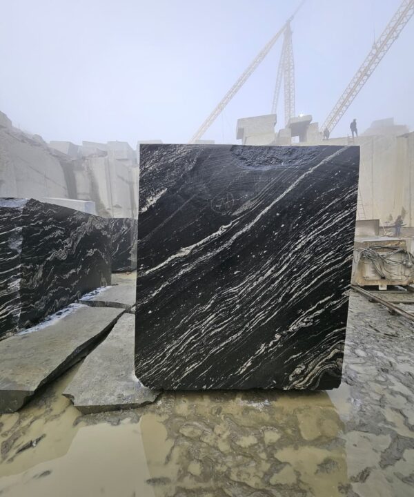 Product Overview: Reliance Titanium Black & Forest Black Granite is a luxurious natural stone celebrated for its striking black background enriched with flowing golden and white veins. Mined from our owned quarry, this granite represents strength, elegance, and timeless beauty — making it a preferred choice for high-end architectural and interior projects across the globe. Each block is a unique creation of nature, offering unmatched character and visual depth. Technical Specifications: Title Reliance Titanium Black & Forest Black Granite Block Stone Type Granite Block Type Gangsaw Block Block Size 300 CM x 180 CM x 180 CM (LXWXH) Color Deep Black with Gold & White Veins Surface Finish Options Wire Saw Cut Density 2960-3000 kg/m3 Compressive Strength 200-250 MPa Water Absorption 0.2%-0.3% Hardness (Mohs) 6 to 7 Porosity Low Origin India Applications Slabs, Countertops, Flooring, Wall Cladding, Interior Key Features: Elegant Aesthetic Appeal: Deep jet-black background enhanced by golden and silver waves — a naturally luxurious look. Superior Strength & Durability: Excellent structural integrity and long-term performance in varied climates. High Polish Retention: Achieves exceptional gloss and mirror-like reflection after finishing. Consistent Texture: Uniform color and grain suitable for large-scale architectural applications. Versatile Application Range: Perfect for multiple interior purposes. Low Maintenance: Resistant to stains, scratches, and moisture, ensuring lasting beauty with minimal upkeep. Export-Grade Blocks: Carefully selected and cut for optimal slab yield and international market standards. Recommended Uses: Kitchen Countertops & Islands Luxury Flooring & Staircases Hotel Lobbies & Reception Areas Wall Cladding & Facades Memorials & Monuments Designer Furniture Tops Why Choose Reliance Titanium Black Granite and Forest Black Granite? Our granite is preferred by export buyers because of: Natural white veins and attractive deep black surface Zero crack, high strength and durability, suitable for projects & reprocessing Consistent Gang Saw block sizes Strict quality checks for each block before shipment Reliable and stable long-term supply Export Capabilities & Payment Terms: We provide smooth, professional export handling with: Payment Options: L/C at sight (Letter of Credit at sight) D/P (Documents Against Payment) T/T advance (if preferred by the buyer) Shipping Documents Provided: Bill of Lading (BL) Commercial Invoice Packing List Certificate of Origin Other documents as per buyer requirements Shipping Price Options: FOB (Indian Port) CNF (any destination port globally) Our logistics team ensures timely loading, documentation, and shipment coordination for a hassle-free experience. About Reliance Mines & Minerals We have a strong presence in the global stone industry, regularly exporting to China, Germany, USA, Oman, and Qatar . Our team is experienced in international trade procedures, ensuring professional communication and smooth cooperation with all partners. We Welcome Your Inquiry If your company is seeking a reliable supplier for premium Titanium black & Forest black granite blocks, we would be pleased to offer quotations, block photos, videos and quarry videos and further details. We look forward to establishing a long-term and successful business relationship with your esteemed company. More About Reliance Titanium Black & Forest Black Granite: Reliance Titanium Black & Forest Black Granite combines natural elegance with engineering excellence. Its bold veins and premium polish bring sophistication to any architectural space, while its robust physical properties ensure durability even in demanding environments. Each block is meticulously extracted and inspected to meet international export quality benchmarks. Reliance Mines & Minerals specializes in the sales and global export of premium granite blocks and slabs. With years of experience in the stone industry, we have established a strong presence in international markets. We are committed to delivering top-quality granite with timely and reliable shipments to major ports worldwide. Our dedicated sales and logistics team is highly skilled in managing export documentation, container loading, and shipping procedures, ensuring a smooth and hassle-free experience for our clients. At the heart of our business is a focus on excellence, professionalism, and customer satisfaction, making us a trusted partner for granite buyers around the globe. 印度 花岗岩 块料 泰坦黑 花岗岩 印度 森林黑 花岗岩 印度 印度 花岗岩 块料, 印度 出口 花岗岩 块, 印度花岗岩原石 中国进口 India granite block Titanium Black granite India Forest Black granite India Granite Blocks Titanium Black Granite Reliance Titanium Black Granite Titanium Black Granite Slabs Polished Titanium Black Granite Bookmatch Titanium Black Granite Titanium Black Granite Exporters India Titanium Black Granite Suppliers Titanium Black Granite Manufacturers Exotic Black Granite with White Veins Deep Black Granite Slabs Mirror Polished Granite Luxury Granite for Interior Walls Natural Stone for Modern Architecture High Gloss Granite Panels Bookmatched Granite Wall Design Black Granite for Hotel Lobby & Flooring Designer Granite Slabs for Projects Indian Granite Exporters Premium Granite from India Granite Slabs for Export Worldwide Granite Supplier Natural Stone Exporter from India Wholesale Granite Supplier Black Granite for Construction & Interiors Architectural Granite Stone Supplier Custom Cut Granite Slabs Export Granite for Wall Cladding Granite for Flooring Granite for Kitchen Countertops Granite for Hotel & Commercial Projects Interior Stone Cladding Luxury Stone for Architects & Designers Black Forest Granite supplier Black Forest Granite manufacturer Black Forest Granite exporter Black Forest Granite quarry Black Forest Granite wholesaler Black Forest Granite seller Buy Black Forest Granite blocks Buy Black Forest Granite slabs Black Forest Granite for flooring Black Forest Granite for countertops Black Forest Granite for wall cladding Black Forest Granite price per sqm Black Forest Granite bulk supplier Black Forest Granite block exporter Black Forest Granite slab manufacturer Black Forest Granite quarry owner Black Forest Granite wholesale price Black Forest Granite large quantity supplier Black Forest Granite custom sizes Black Forest Granite supplier India Black Forest Granite manufacturer India Black Forest Granite exporter India Black Forest Granite quarry India Black Forest Granite supplier [Your City/State] Black Forest Granite international exporter Premium Black Forest Granite supplier Natural Black Forest Granite stone High quality Black Forest Granite slabs Black Forest Granite direct from quarry Black Forest Granite blocks for export Black Forest Granite polished slabs Black granite stone supplier Natural granite stone exporter Indian black granite manufacturer Granite blocks and slabs exporter Dimension stone granite supplier Nebula Wave Granite Stone Manufacturer Export Quality Blocks Supplier Quarry Reliance Mines India Titanium Black Granite Stone Manufacturer Export Quality Blocks Supplier Quarry Reliance Mines India Cosmic Black Granite Stone Manufacturer Export Quality Blocks Supplier Quarry Reliance Mines India Marquina Black Granite Stone Manufacturer Export Quality Blocks Supplier Quarry Reliance Mines India Black Forest Granite Stone Manufacturer Export Quality Blocks Supplier Quarry Reliance Mines India #TitaniumBlackGranite #RelianceGranite #IndianGranite #GraniteExporter #LuxuryGranite #GraniteSupplier #BlackGranite #NaturalStoneIndia #GraniteSlabs #GraniteBookmatch #InteriorDesignStone #ArchitecturalStone #PremiumGranite #GraniteExport #GraniteDesigns #reliancemines #granite #marble #stone #quarry #forestblackgranite