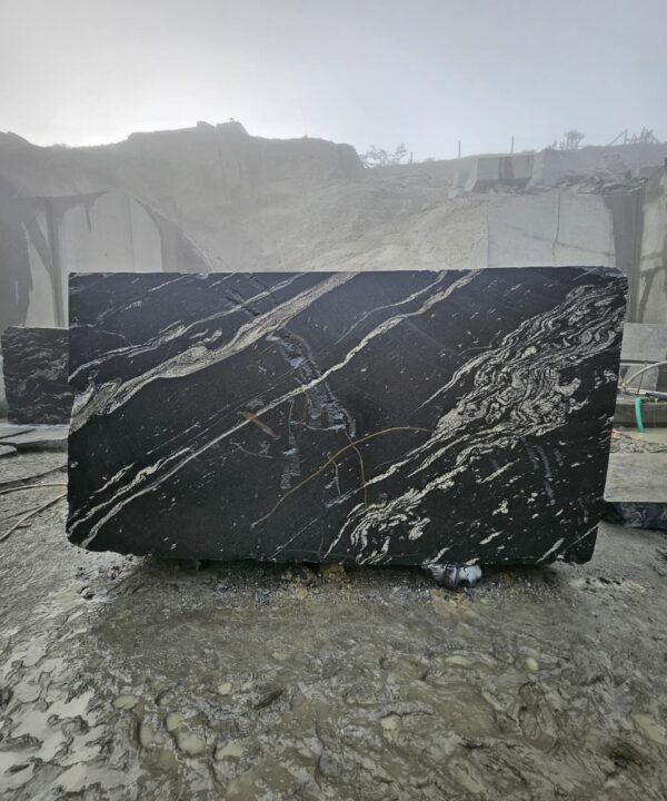 Product Overview: Reliance Titanium Black & Forest Black Granite is a luxurious natural stone celebrated for its striking black background enriched with flowing golden and white veins. Mined from our owned quarry, this granite represents strength, elegance, and timeless beauty — making it a preferred choice for high-end architectural and interior projects across the globe. Each block is a unique creation of nature, offering unmatched character and visual depth. Technical Specifications: Title Reliance Titanium Black & Forest Black Granite Block Stone Type Granite Block Type Gangsaw Block Block Size 300 CM x 180 CM x 180 CM (LXWXH) Color Deep Black with Gold & White Veins Surface Finish Options Wire Saw Cut Density 2960-3000 kg/m3 Compressive Strength 200-250 MPa Water Absorption 0.2%-0.3% Hardness (Mohs) 6 to 7 Porosity Low Origin India Applications Slabs, Countertops, Flooring, Wall Cladding, Interior Key Features: Elegant Aesthetic Appeal: Deep jet-black background enhanced by golden and silver waves — a naturally luxurious look. Superior Strength & Durability: Excellent structural integrity and long-term performance in varied climates. High Polish Retention: Achieves exceptional gloss and mirror-like reflection after finishing. Consistent Texture: Uniform color and grain suitable for large-scale architectural applications. Versatile Application Range: Perfect for multiple interior purposes. Low Maintenance: Resistant to stains, scratches, and moisture, ensuring lasting beauty with minimal upkeep. Export-Grade Blocks: Carefully selected and cut for optimal slab yield and international market standards. Recommended Uses: Kitchen Countertops & Islands Luxury Flooring & Staircases Hotel Lobbies & Reception Areas Wall Cladding & Facades Memorials & Monuments Designer Furniture Tops Why Choose Reliance Titanium Black Granite and Forest Black Granite? Our granite is preferred by export buyers because of: Natural white veins and attractive deep black surface Zero crack, high strength and durability, suitable for projects & reprocessing Consistent Gang Saw block sizes Strict quality checks for each block before shipment Reliable and stable long-term supply Export Capabilities & Payment Terms: We provide smooth, professional export handling with: Payment Options: L/C at sight (Letter of Credit at sight) D/P (Documents Against Payment) T/T advance (if preferred by the buyer) Shipping Documents Provided: Bill of Lading (BL) Commercial Invoice Packing List Certificate of Origin Other documents as per buyer requirements Shipping Price Options: FOB (Indian Port) CNF (any destination port globally) Our logistics team ensures timely loading, documentation, and shipment coordination for a hassle-free experience. About Reliance Mines & Minerals We have a strong presence in the global stone industry, regularly exporting to China, Germany, USA, Oman, and Qatar . Our team is experienced in international trade procedures, ensuring professional communication and smooth cooperation with all partners. We Welcome Your Inquiry If your company is seeking a reliable supplier for premium Titanium black & Forest black granite blocks, we would be pleased to offer quotations, block photos, videos and quarry videos and further details. We look forward to establishing a long-term and successful business relationship with your esteemed company. More About Reliance Titanium Black & Forest Black Granite: Reliance Titanium Black & Forest Black Granite combines natural elegance with engineering excellence. Its bold veins and premium polish bring sophistication to any architectural space, while its robust physical properties ensure durability even in demanding environments. Each block is meticulously extracted and inspected to meet international export quality benchmarks. Reliance Mines & Minerals specializes in the sales and global export of premium granite blocks and slabs. With years of experience in the stone industry, we have established a strong presence in international markets. We are committed to delivering top-quality granite with timely and reliable shipments to major ports worldwide. Our dedicated sales and logistics team is highly skilled in managing export documentation, container loading, and shipping procedures, ensuring a smooth and hassle-free experience for our clients. At the heart of our business is a focus on excellence, professionalism, and customer satisfaction, making us a trusted partner for granite buyers around the globe. 印度 花岗岩 块料 泰坦黑 花岗岩 印度 森林黑 花岗岩 印度 印度 花岗岩 块料, 印度 出口 花岗岩 块, 印度花岗岩原石 中国进口 India granite block Titanium Black granite India Forest Black granite India Granite Blocks Titanium Black Granite Reliance Titanium Black Granite Titanium Black Granite Slabs Polished Titanium Black Granite Bookmatch Titanium Black Granite Titanium Black Granite Exporters India Titanium Black Granite Suppliers Titanium Black Granite Manufacturers Exotic Black Granite with White Veins Deep Black Granite Slabs Mirror Polished Granite Luxury Granite for Interior Walls Natural Stone for Modern Architecture High Gloss Granite Panels Bookmatched Granite Wall Design Black Granite for Hotel Lobby & Flooring Designer Granite Slabs for Projects Indian Granite Exporters Premium Granite from India Granite Slabs for Export Worldwide Granite Supplier Natural Stone Exporter from India Wholesale Granite Supplier Black Granite for Construction & Interiors Architectural Granite Stone Supplier Custom Cut Granite Slabs Export Granite for Wall Cladding Granite for Flooring Granite for Kitchen Countertops Granite for Hotel & Commercial Projects Interior Stone Cladding Luxury Stone for Architects & Designers Black Forest Granite supplier Black Forest Granite manufacturer Black Forest Granite exporter Black Forest Granite quarry Black Forest Granite wholesaler Black Forest Granite seller Buy Black Forest Granite blocks Buy Black Forest Granite slabs Black Forest Granite for flooring Black Forest Granite for countertops Black Forest Granite for wall cladding Black Forest Granite price per sqm Black Forest Granite bulk supplier Black Forest Granite block exporter Black Forest Granite slab manufacturer Black Forest Granite quarry owner Black Forest Granite wholesale price Black Forest Granite large quantity supplier Black Forest Granite custom sizes Black Forest Granite supplier India Black Forest Granite manufacturer India Black Forest Granite exporter India Black Forest Granite quarry India Black Forest Granite supplier [Your City/State] Black Forest Granite international exporter Premium Black Forest Granite supplier Natural Black Forest Granite stone High quality Black Forest Granite slabs Black Forest Granite direct from quarry Black Forest Granite blocks for export Black Forest Granite polished slabs Black granite stone supplier Natural granite stone exporter Indian black granite manufacturer Granite blocks and slabs exporter Dimension stone granite supplier Nebula Wave Granite Stone Manufacturer Export Quality Blocks Supplier Quarry Reliance Mines India Titanium Black Granite Stone Manufacturer Export Quality Blocks Supplier Quarry Reliance Mines India Cosmic Black Granite Stone Manufacturer Export Quality Blocks Supplier Quarry Reliance Mines India Marquina Black Granite Stone Manufacturer Export Quality Blocks Supplier Quarry Reliance Mines India Black Forest Granite Stone Manufacturer Export Quality Blocks Supplier Quarry Reliance Mines India #TitaniumBlackGranite #RelianceGranite #IndianGranite #GraniteExporter #LuxuryGranite #GraniteSupplier #BlackGranite #NaturalStoneIndia #GraniteSlabs #GraniteBookmatch #InteriorDesignStone #ArchitecturalStone #PremiumGranite #GraniteExport #GraniteDesigns #reliancemines #granite #marble #stone #quarry #forestblackgranite