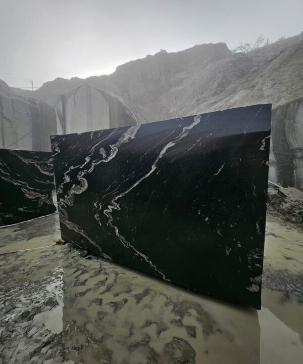 Product Overview: Reliance Titanium Black & Forest Black Granite is a luxurious natural stone celebrated for its striking black background enriched with flowing golden and white veins. Mined from our owned quarry, this granite represents strength, elegance, and timeless beauty — making it a preferred choice for high-end architectural and interior projects across the globe. Each block is a unique creation of nature, offering unmatched character and visual depth. Technical Specifications: Title Reliance Titanium Black & Forest Black Granite Block Stone Type Granite Block Type Gangsaw Block Block Size 300 CM x 180 CM x 180 CM (LXWXH) Color Deep Black with Gold & White Veins Surface Finish Options Wire Saw Cut Density 2960-3000 kg/m3 Compressive Strength 200-250 MPa Water Absorption 0.2%-0.3% Hardness (Mohs) 6 to 7 Porosity Low Origin India Applications Slabs, Countertops, Flooring, Wall Cladding, Interior Key Features: Elegant Aesthetic Appeal: Deep jet-black background enhanced by golden and silver waves — a naturally luxurious look. Superior Strength & Durability: Excellent structural integrity and long-term performance in varied climates. High Polish Retention: Achieves exceptional gloss and mirror-like reflection after finishing. Consistent Texture: Uniform color and grain suitable for large-scale architectural applications. Versatile Application Range: Perfect for multiple interior purposes. Low Maintenance: Resistant to stains, scratches, and moisture, ensuring lasting beauty with minimal upkeep. Export-Grade Blocks: Carefully selected and cut for optimal slab yield and international market standards. Recommended Uses: Kitchen Countertops & Islands Luxury Flooring & Staircases Hotel Lobbies & Reception Areas Wall Cladding & Facades Memorials & Monuments Designer Furniture Tops Why Choose Reliance Titanium Black Granite and Forest Black Granite? Our granite is preferred by export buyers because of: Natural white veins and attractive deep black surface Zero crack, high strength and durability, suitable for projects & reprocessing Consistent Gang Saw block sizes Strict quality checks for each block before shipment Reliable and stable long-term supply Export Capabilities & Payment Terms: We provide smooth, professional export handling with: Payment Options: L/C at sight (Letter of Credit at sight) D/P (Documents Against Payment) T/T advance (if preferred by the buyer) Shipping Documents Provided: Bill of Lading (BL) Commercial Invoice Packing List Certificate of Origin Other documents as per buyer requirements Shipping Price Options: FOB (Indian Port) CNF (any destination port globally) Our logistics team ensures timely loading, documentation, and shipment coordination for a hassle-free experience. About Reliance Mines & Minerals We have a strong presence in the global stone industry, regularly exporting to China, Germany, USA, Oman, and Qatar . Our team is experienced in international trade procedures, ensuring professional communication and smooth cooperation with all partners. We Welcome Your Inquiry If your company is seeking a reliable supplier for premium Titanium black & Forest black granite blocks, we would be pleased to offer quotations, block photos, videos and quarry videos and further details. We look forward to establishing a long-term and successful business relationship with your esteemed company. More About Reliance Titanium Black & Forest Black Granite: Reliance Titanium Black & Forest Black Granite combines natural elegance with engineering excellence. Its bold veins and premium polish bring sophistication to any architectural space, while its robust physical properties ensure durability even in demanding environments. Each block is meticulously extracted and inspected to meet international export quality benchmarks. Reliance Mines & Minerals specializes in the sales and global export of premium granite blocks and slabs. With years of experience in the stone industry, we have established a strong presence in international markets. We are committed to delivering top-quality granite with timely and reliable shipments to major ports worldwide. Our dedicated sales and logistics team is highly skilled in managing export documentation, container loading, and shipping procedures, ensuring a smooth and hassle-free experience for our clients. At the heart of our business is a focus on excellence, professionalism, and customer satisfaction, making us a trusted partner for granite buyers around the globe. 印度 花岗岩 块料 泰坦黑 花岗岩 印度 森林黑 花岗岩 印度 印度 花岗岩 块料, 印度 出口 花岗岩 块, 印度花岗岩原石 中国进口 India granite block Titanium Black granite India Forest Black granite India Granite Blocks Titanium Black Granite Reliance Titanium Black Granite Titanium Black Granite Slabs Polished Titanium Black Granite Bookmatch Titanium Black Granite Titanium Black Granite Exporters India Titanium Black Granite Suppliers Titanium Black Granite Manufacturers Exotic Black Granite with White Veins Deep Black Granite Slabs Mirror Polished Granite Luxury Granite for Interior Walls Natural Stone for Modern Architecture High Gloss Granite Panels Bookmatched Granite Wall Design Black Granite for Hotel Lobby & Flooring Designer Granite Slabs for Projects Indian Granite Exporters Premium Granite from India Granite Slabs for Export Worldwide Granite Supplier Natural Stone Exporter from India Wholesale Granite Supplier Black Granite for Construction & Interiors Architectural Granite Stone Supplier Custom Cut Granite Slabs Export Granite for Wall Cladding Granite for Flooring Granite for Kitchen Countertops Granite for Hotel & Commercial Projects Interior Stone Cladding Luxury Stone for Architects & Designers Black Forest Granite supplier Black Forest Granite manufacturer Black Forest Granite exporter Black Forest Granite quarry Black Forest Granite wholesaler Black Forest Granite seller Buy Black Forest Granite blocks Buy Black Forest Granite slabs Black Forest Granite for flooring Black Forest Granite for countertops Black Forest Granite for wall cladding Black Forest Granite price per sqm Black Forest Granite bulk supplier Black Forest Granite block exporter Black Forest Granite slab manufacturer Black Forest Granite quarry owner Black Forest Granite wholesale price Black Forest Granite large quantity supplier Black Forest Granite custom sizes Black Forest Granite supplier India Black Forest Granite manufacturer India Black Forest Granite exporter India Black Forest Granite quarry India Black Forest Granite supplier [Your City/State] Black Forest Granite international exporter Premium Black Forest Granite supplier Natural Black Forest Granite stone High quality Black Forest Granite slabs Black Forest Granite direct from quarry Black Forest Granite blocks for export Black Forest Granite polished slabs Black granite stone supplier Natural granite stone exporter Indian black granite manufacturer Granite blocks and slabs exporter Dimension stone granite supplier Nebula Wave Granite Stone Manufacturer Export Quality Blocks Supplier Quarry Reliance Mines India Titanium Black Granite Stone Manufacturer Export Quality Blocks Supplier Quarry Reliance Mines India Cosmic Black Granite Stone Manufacturer Export Quality Blocks Supplier Quarry Reliance Mines India Marquina Black Granite Stone Manufacturer Export Quality Blocks Supplier Quarry Reliance Mines India Black Forest Granite Stone Manufacturer Export Quality Blocks Supplier Quarry Reliance Mines India #TitaniumBlackGranite #RelianceGranite #IndianGranite #GraniteExporter #LuxuryGranite #GraniteSupplier #BlackGranite #NaturalStoneIndia #GraniteSlabs #GraniteBookmatch #InteriorDesignStone #ArchitecturalStone #PremiumGranite #GraniteExport #GraniteDesigns #reliancemines #granite #marble #stone #quarry #forestblackgranite