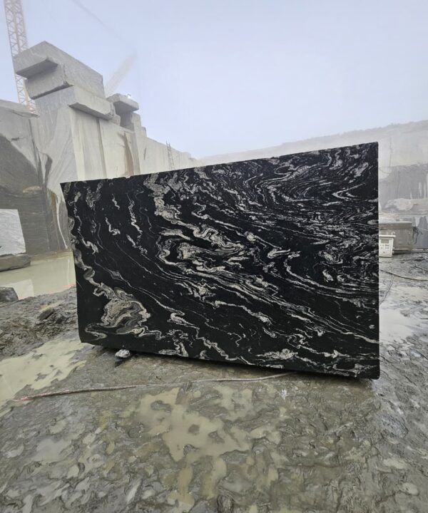 Product Overview: Reliance Titanium Black & Forest Black Granite is a luxurious natural stone celebrated for its striking black background enriched with flowing golden and white veins. Mined from our owned quarry, this granite represents strength, elegance, and timeless beauty — making it a preferred choice for high-end architectural and interior projects across the globe. Each block is a unique creation of nature, offering unmatched character and visual depth. Technical Specifications: Title Reliance Titanium Black & Forest Black Granite Block Stone Type Granite Block Type Gangsaw Block Block Size 300 CM x 180 CM x 180 CM (LXWXH) Color Deep Black with Gold & White Veins Surface Finish Options Wire Saw Cut Density 2960-3000 kg/m3 Compressive Strength 200-250 MPa Water Absorption 0.2%-0.3% Hardness (Mohs) 6 to 7 Porosity Low Origin India Applications Slabs, Countertops, Flooring, Wall Cladding, Interior Key Features: Elegant Aesthetic Appeal: Deep jet-black background enhanced by golden and silver waves — a naturally luxurious look. Superior Strength & Durability: Excellent structural integrity and long-term performance in varied climates. High Polish Retention: Achieves exceptional gloss and mirror-like reflection after finishing. Consistent Texture: Uniform color and grain suitable for large-scale architectural applications. Versatile Application Range: Perfect for multiple interior purposes. Low Maintenance: Resistant to stains, scratches, and moisture, ensuring lasting beauty with minimal upkeep. Export-Grade Blocks: Carefully selected and cut for optimal slab yield and international market standards. Recommended Uses: Kitchen Countertops & Islands Luxury Flooring & Staircases Hotel Lobbies & Reception Areas Wall Cladding & Facades Memorials & Monuments Designer Furniture Tops Why Choose Reliance Titanium Black Granite and Forest Black Granite? Our granite is preferred by export buyers because of: Natural white veins and attractive deep black surface Zero crack, high strength and durability, suitable for projects & reprocessing Consistent Gang Saw block sizes Strict quality checks for each block before shipment Reliable and stable long-term supply Export Capabilities & Payment Terms: We provide smooth, professional export handling with: Payment Options: L/C at sight (Letter of Credit at sight) D/P (Documents Against Payment) T/T advance (if preferred by the buyer) Shipping Documents Provided: Bill of Lading (BL) Commercial Invoice Packing List Certificate of Origin Other documents as per buyer requirements Shipping Price Options: FOB (Indian Port) CNF (any destination port globally) Our logistics team ensures timely loading, documentation, and shipment coordination for a hassle-free experience. About Reliance Mines & Minerals We have a strong presence in the global stone industry, regularly exporting to China, Germany, USA, Oman, and Qatar . Our team is experienced in international trade procedures, ensuring professional communication and smooth cooperation with all partners. We Welcome Your Inquiry If your company is seeking a reliable supplier for premium Titanium black & Forest black granite blocks, we would be pleased to offer quotations, block photos, videos and quarry videos and further details. We look forward to establishing a long-term and successful business relationship with your esteemed company. More About Reliance Titanium Black & Forest Black Granite: Reliance Titanium Black & Forest Black Granite combines natural elegance with engineering excellence. Its bold veins and premium polish bring sophistication to any architectural space, while its robust physical properties ensure durability even in demanding environments. Each block is meticulously extracted and inspected to meet international export quality benchmarks. Reliance Mines & Minerals specializes in the sales and global export of premium granite blocks and slabs. With years of experience in the stone industry, we have established a strong presence in international markets. We are committed to delivering top-quality granite with timely and reliable shipments to major ports worldwide. Our dedicated sales and logistics team is highly skilled in managing export documentation, container loading, and shipping procedures, ensuring a smooth and hassle-free experience for our clients. At the heart of our business is a focus on excellence, professionalism, and customer satisfaction, making us a trusted partner for granite buyers around the globe. 印度 花岗岩 块料 泰坦黑 花岗岩 印度 森林黑 花岗岩 印度 印度 花岗岩 块料, 印度 出口 花岗岩 块, 印度花岗岩原石 中国进口 India granite block Titanium Black granite India Forest Black granite India Granite Blocks Titanium Black Granite Reliance Titanium Black Granite Titanium Black Granite Slabs Polished Titanium Black Granite Bookmatch Titanium Black Granite Titanium Black Granite Exporters India Titanium Black Granite Suppliers Titanium Black Granite Manufacturers Exotic Black Granite with White Veins Deep Black Granite Slabs Mirror Polished Granite Luxury Granite for Interior Walls Natural Stone for Modern Architecture High Gloss Granite Panels Bookmatched Granite Wall Design Black Granite for Hotel Lobby & Flooring Designer Granite Slabs for Projects Indian Granite Exporters Premium Granite from India Granite Slabs for Export Worldwide Granite Supplier Natural Stone Exporter from India Wholesale Granite Supplier Black Granite for Construction & Interiors Architectural Granite Stone Supplier Custom Cut Granite Slabs Export Granite for Wall Cladding Granite for Flooring Granite for Kitchen Countertops Granite for Hotel & Commercial Projects Interior Stone Cladding Luxury Stone for Architects & Designers Black Forest Granite supplier Black Forest Granite manufacturer Black Forest Granite exporter Black Forest Granite quarry Black Forest Granite wholesaler Black Forest Granite seller Buy Black Forest Granite blocks Buy Black Forest Granite slabs Black Forest Granite for flooring Black Forest Granite for countertops Black Forest Granite for wall cladding Black Forest Granite price per sqm Black Forest Granite bulk supplier Black Forest Granite block exporter Black Forest Granite slab manufacturer Black Forest Granite quarry owner Black Forest Granite wholesale price Black Forest Granite large quantity supplier Black Forest Granite custom sizes Black Forest Granite supplier India Black Forest Granite manufacturer India Black Forest Granite exporter India Black Forest Granite quarry India Black Forest Granite supplier [Your City/State] Black Forest Granite international exporter Premium Black Forest Granite supplier Natural Black Forest Granite stone High quality Black Forest Granite slabs Black Forest Granite direct from quarry Black Forest Granite blocks for export Black Forest Granite polished slabs Black granite stone supplier Natural granite stone exporter Indian black granite manufacturer Granite blocks and slabs exporter Dimension stone granite supplier Nebula Wave Granite Stone Manufacturer Export Quality Blocks Supplier Quarry Reliance Mines India Titanium Black Granite Stone Manufacturer Export Quality Blocks Supplier Quarry Reliance Mines India Cosmic Black Granite Stone Manufacturer Export Quality Blocks Supplier Quarry Reliance Mines India Marquina Black Granite Stone Manufacturer Export Quality Blocks Supplier Quarry Reliance Mines India Black Forest Granite Stone Manufacturer Export Quality Blocks Supplier Quarry Reliance Mines India #TitaniumBlackGranite #RelianceGranite #IndianGranite #GraniteExporter #LuxuryGranite #GraniteSupplier #BlackGranite #NaturalStoneIndia #GraniteSlabs #GraniteBookmatch #InteriorDesignStone #ArchitecturalStone #PremiumGranite #GraniteExport #GraniteDesigns #reliancemines #granite #marble #stone #quarry #forestblackgranite