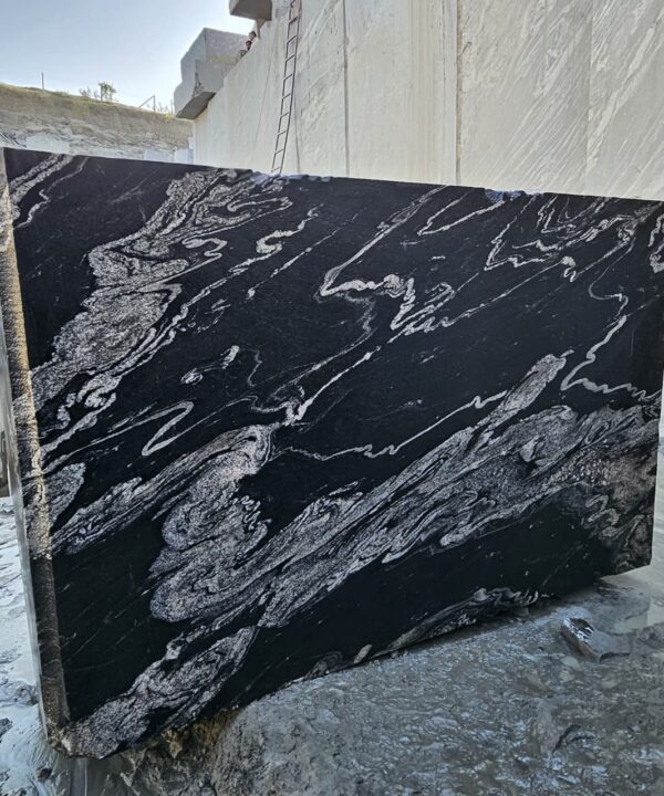 Product Overview: Reliance Titanium Black & Forest Black Granite is a luxurious natural stone celebrated for its striking black background enriched with flowing golden and white veins. Mined from our owned quarry, this granite represents strength, elegance, and timeless beauty — making it a preferred choice for high-end architectural and interior projects across the globe. Each block is a unique creation of nature, offering unmatched character and visual depth. Technical Specifications: Title Reliance Titanium Black & Forest Black Granite Block Stone Type Granite Block Type Gangsaw Block Block Size 300 CM x 180 CM x 180 CM (LXWXH) Color Deep Black with Gold & White Veins Surface Finish Options Wire Saw Cut Density 2960-3000 kg/m3 Compressive Strength 200-250 MPa Water Absorption 0.2%-0.3% Hardness (Mohs) 6 to 7 Porosity Low Origin India Applications Slabs, Countertops, Flooring, Wall Cladding, Interior Key Features: Elegant Aesthetic Appeal: Deep jet-black background enhanced by golden and silver waves — a naturally luxurious look. Superior Strength & Durability: Excellent structural integrity and long-term performance in varied climates. High Polish Retention: Achieves exceptional gloss and mirror-like reflection after finishing. Consistent Texture: Uniform color and grain suitable for large-scale architectural applications. Versatile Application Range: Perfect for multiple interior purposes. Low Maintenance: Resistant to stains, scratches, and moisture, ensuring lasting beauty with minimal upkeep. Export-Grade Blocks: Carefully selected and cut for optimal slab yield and international market standards. Recommended Uses: Kitchen Countertops & Islands Luxury Flooring & Staircases Hotel Lobbies & Reception Areas Wall Cladding & Facades Memorials & Monuments Designer Furniture Tops Why Choose Reliance Titanium Black Granite and Forest Black Granite? Our granite is preferred by export buyers because of: Natural white veins and attractive deep black surface Zero crack, high strength and durability, suitable for projects & reprocessing Consistent Gang Saw block sizes Strict quality checks for each block before shipment Reliable and stable long-term supply Export Capabilities & Payment Terms: We provide smooth, professional export handling with: Payment Options: L/C at sight (Letter of Credit at sight) D/P (Documents Against Payment) T/T advance (if preferred by the buyer) Shipping Documents Provided: Bill of Lading (BL) Commercial Invoice Packing List Certificate of Origin Other documents as per buyer requirements Shipping Price Options: FOB (Indian Port) CNF (any destination port globally) Our logistics team ensures timely loading, documentation, and shipment coordination for a hassle-free experience. About Reliance Mines & Minerals We have a strong presence in the global stone industry, regularly exporting to China, Germany, USA, Oman, and Qatar . Our team is experienced in international trade procedures, ensuring professional communication and smooth cooperation with all partners. We Welcome Your Inquiry If your company is seeking a reliable supplier for premium Titanium black & Forest black granite blocks, we would be pleased to offer quotations, block photos, videos and quarry videos and further details. We look forward to establishing a long-term and successful business relationship with your esteemed company. More About Reliance Titanium Black & Forest Black Granite: Reliance Titanium Black & Forest Black Granite combines natural elegance with engineering excellence. Its bold veins and premium polish bring sophistication to any architectural space, while its robust physical properties ensure durability even in demanding environments. Each block is meticulously extracted and inspected to meet international export quality benchmarks. Reliance Mines & Minerals specializes in the sales and global export of premium granite blocks and slabs. With years of experience in the stone industry, we have established a strong presence in international markets. We are committed to delivering top-quality granite with timely and reliable shipments to major ports worldwide. Our dedicated sales and logistics team is highly skilled in managing export documentation, container loading, and shipping procedures, ensuring a smooth and hassle-free experience for our clients. At the heart of our business is a focus on excellence, professionalism, and customer satisfaction, making us a trusted partner for granite buyers around the globe. 印度 花岗岩 块料 泰坦黑 花岗岩 印度 森林黑 花岗岩 印度 印度 花岗岩 块料, 印度 出口 花岗岩 块, 印度花岗岩原石 中国进口 India granite block Titanium Black granite India Forest Black granite India Granite Blocks Titanium Black Granite Reliance Titanium Black Granite Titanium Black Granite Slabs Polished Titanium Black Granite Bookmatch Titanium Black Granite Titanium Black Granite Exporters India Titanium Black Granite Suppliers Titanium Black Granite Manufacturers Exotic Black Granite with White Veins Deep Black Granite Slabs Mirror Polished Granite Luxury Granite for Interior Walls Natural Stone for Modern Architecture High Gloss Granite Panels Bookmatched Granite Wall Design Black Granite for Hotel Lobby & Flooring Designer Granite Slabs for Projects Indian Granite Exporters Premium Granite from India Granite Slabs for Export Worldwide Granite Supplier Natural Stone Exporter from India Wholesale Granite Supplier Black Granite for Construction & Interiors Architectural Granite Stone Supplier Custom Cut Granite Slabs Export Granite for Wall Cladding Granite for Flooring Granite for Kitchen Countertops Granite for Hotel & Commercial Projects Interior Stone Cladding Luxury Stone for Architects & Designers Black Forest Granite supplier Black Forest Granite manufacturer Black Forest Granite exporter Black Forest Granite quarry Black Forest Granite wholesaler Black Forest Granite seller Buy Black Forest Granite blocks Buy Black Forest Granite slabs Black Forest Granite for flooring Black Forest Granite for countertops Black Forest Granite for wall cladding Black Forest Granite price per sqm Black Forest Granite bulk supplier Black Forest Granite block exporter Black Forest Granite slab manufacturer Black Forest Granite quarry owner Black Forest Granite wholesale price Black Forest Granite large quantity supplier Black Forest Granite custom sizes Black Forest Granite supplier India Black Forest Granite manufacturer India Black Forest Granite exporter India Black Forest Granite quarry India Black Forest Granite supplier [Your City/State] Black Forest Granite international exporter Premium Black Forest Granite supplier Natural Black Forest Granite stone High quality Black Forest Granite slabs Black Forest Granite direct from quarry Black Forest Granite blocks for export Black Forest Granite polished slabs Black granite stone supplier Natural granite stone exporter Indian black granite manufacturer Granite blocks and slabs exporter Dimension stone granite supplier Nebula Wave Granite Stone Manufacturer Export Quality Blocks Supplier Quarry Reliance Mines India Titanium Black Granite Stone Manufacturer Export Quality Blocks Supplier Quarry Reliance Mines India Cosmic Black Granite Stone Manufacturer Export Quality Blocks Supplier Quarry Reliance Mines India Marquina Black Granite Stone Manufacturer Export Quality Blocks Supplier Quarry Reliance Mines India Black Forest Granite Stone Manufacturer Export Quality Blocks Supplier Quarry Reliance Mines India #TitaniumBlackGranite #RelianceGranite #IndianGranite #GraniteExporter #LuxuryGranite #GraniteSupplier #BlackGranite #NaturalStoneIndia #GraniteSlabs #GraniteBookmatch #InteriorDesignStone #ArchitecturalStone #PremiumGranite #GraniteExport #GraniteDesigns #reliancemines #granite #marble #stone #quarry #forestblackgranite