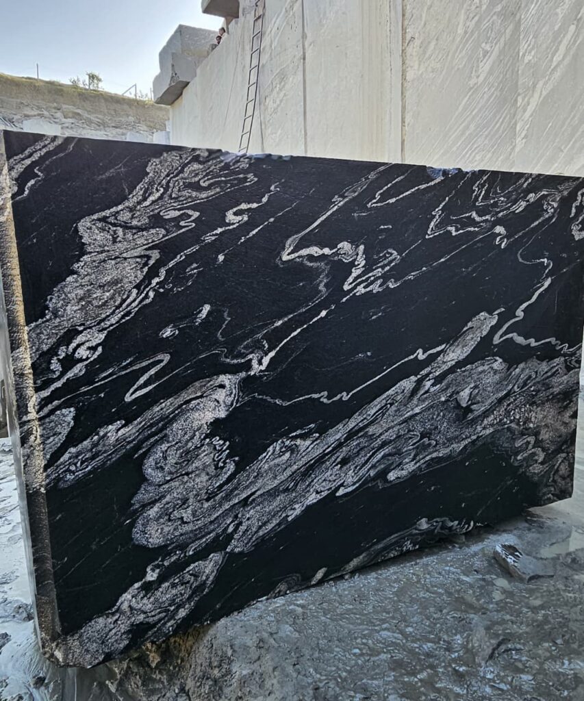 Product Overview: Reliance Titanium Black & Forest Black Granite is a luxurious natural stone celebrated for its striking black background enriched with flowing golden and white veins. Mined from our owned quarry, this granite represents strength, elegance, and timeless beauty — making it a preferred choice for high-end architectural and interior projects across the globe. Each block is a unique creation of nature, offering unmatched character and visual depth. Technical Specifications: Title Reliance Titanium Black & Forest Black Granite Block Stone Type Granite Block Type Gangsaw Block Block Size 300 CM x 180 CM x 180 CM (LXWXH) Color Deep Black with Gold & White Veins Surface Finish Options Wire Saw Cut Density 2960-3000 kg/m3 Compressive Strength 200-250 MPa Water Absorption 0.2%-0.3% Hardness (Mohs) 6 to 7 Porosity Low Origin India Applications Slabs, Countertops, Flooring, Wall Cladding, Interior Key Features: Elegant Aesthetic Appeal: Deep jet-black background enhanced by golden and silver waves — a naturally luxurious look. Superior Strength & Durability: Excellent structural integrity and long-term performance in varied climates. High Polish Retention: Achieves exceptional gloss and mirror-like reflection after finishing. Consistent Texture: Uniform color and grain suitable for large-scale architectural applications. Versatile Application Range: Perfect for multiple interior purposes. Low Maintenance: Resistant to stains, scratches, and moisture, ensuring lasting beauty with minimal upkeep. Export-Grade Blocks: Carefully selected and cut for optimal slab yield and international market standards. Recommended Uses: Kitchen Countertops & Islands Luxury Flooring & Staircases Hotel Lobbies & Reception Areas Wall Cladding & Facades Memorials & Monuments Designer Furniture Tops Why Choose Reliance Titanium Black Granite and Forest Black Granite? Our granite is preferred by export buyers because of: Natural white veins and attractive deep black surface Zero crack, high strength and durability, suitable for projects & reprocessing Consistent Gang Saw block sizes Strict quality checks for each block before shipment Reliable and stable long-term supply Export Capabilities & Payment Terms: We provide smooth, professional export handling with: Payment Options: L/C at sight (Letter of Credit at sight) D/P (Documents Against Payment) T/T advance (if preferred by the buyer) Shipping Documents Provided: Bill of Lading (BL) Commercial Invoice Packing List Certificate of Origin Other documents as per buyer requirements Shipping Price Options: FOB (Indian Port) CNF (any destination port globally) Our logistics team ensures timely loading, documentation, and shipment coordination for a hassle-free experience. About Reliance Mines & Minerals We have a strong presence in the global stone industry, regularly exporting to China, Germany, USA, Oman, and Qatar . Our team is experienced in international trade procedures, ensuring professional communication and smooth cooperation with all partners. We Welcome Your Inquiry If your company is seeking a reliable supplier for premium Titanium black & Forest black granite blocks, we would be pleased to offer quotations, block photos, videos and quarry videos and further details. We look forward to establishing a long-term and successful business relationship with your esteemed company. More About Reliance Titanium Black & Forest Black Granite: Reliance Titanium Black & Forest Black Granite combines natural elegance with engineering excellence. Its bold veins and premium polish bring sophistication to any architectural space, while its robust physical properties ensure durability even in demanding environments. Each block is meticulously extracted and inspected to meet international export quality benchmarks. Reliance Mines & Minerals specializes in the sales and global export of premium granite blocks and slabs. With years of experience in the stone industry, we have established a strong presence in international markets. We are committed to delivering top-quality granite with timely and reliable shipments to major ports worldwide. Our dedicated sales and logistics team is highly skilled in managing export documentation, container loading, and shipping procedures, ensuring a smooth and hassle-free experience for our clients. At the heart of our business is a focus on excellence, professionalism, and customer satisfaction, making us a trusted partner for granite buyers around the globe. 印度 花岗岩 块料 泰坦黑 花岗岩 印度 森林黑 花岗岩 印度 印度 花岗岩 块料, 印度 出口 花岗岩 块, 印度花岗岩原石 中国进口 India granite block Titanium Black granite India Forest Black granite India Granite Blocks Titanium Black Granite Reliance Titanium Black Granite Titanium Black Granite Slabs Polished Titanium Black Granite Bookmatch Titanium Black Granite Titanium Black Granite Exporters India Titanium Black Granite Suppliers Titanium Black Granite Manufacturers Exotic Black Granite with White Veins Deep Black Granite Slabs Mirror Polished Granite Luxury Granite for Interior Walls Natural Stone for Modern Architecture High Gloss Granite Panels Bookmatched Granite Wall Design Black Granite for Hotel Lobby & Flooring Designer Granite Slabs for Projects Indian Granite Exporters Premium Granite from India Granite Slabs for Export Worldwide Granite Supplier Natural Stone Exporter from India Wholesale Granite Supplier Black Granite for Construction & Interiors Architectural Granite Stone Supplier Custom Cut Granite Slabs Export Granite for Wall Cladding Granite for Flooring Granite for Kitchen Countertops Granite for Hotel & Commercial Projects Interior Stone Cladding Luxury Stone for Architects & Designers Black Forest Granite supplier Black Forest Granite manufacturer Black Forest Granite exporter Black Forest Granite quarry Black Forest Granite wholesaler Black Forest Granite seller Buy Black Forest Granite blocks Buy Black Forest Granite slabs Black Forest Granite for flooring Black Forest Granite for countertops Black Forest Granite for wall cladding Black Forest Granite price per sqm Black Forest Granite bulk supplier Black Forest Granite block exporter Black Forest Granite slab manufacturer Black Forest Granite quarry owner Black Forest Granite wholesale price Black Forest Granite large quantity supplier Black Forest Granite custom sizes Black Forest Granite supplier India Black Forest Granite manufacturer India Black Forest Granite exporter India Black Forest Granite quarry India Black Forest Granite supplier [Your City/State] Black Forest Granite international exporter Premium Black Forest Granite supplier Natural Black Forest Granite stone High quality Black Forest Granite slabs Black Forest Granite direct from quarry Black Forest Granite blocks for export Black Forest Granite polished slabs Black granite stone supplier Natural granite stone exporter Indian black granite manufacturer Granite blocks and slabs exporter Dimension stone granite supplier Nebula Wave Granite Stone Manufacturer Export Quality Blocks Supplier Quarry Reliance Mines India Titanium Black Granite Stone Manufacturer Export Quality Blocks Supplier Quarry Reliance Mines India Cosmic Black Granite Stone Manufacturer Export Quality Blocks Supplier Quarry Reliance Mines India Marquina Black Granite Stone Manufacturer Export Quality Blocks Supplier Quarry Reliance Mines India Black Forest Granite Stone Manufacturer Export Quality Blocks Supplier Quarry Reliance Mines India #TitaniumBlackGranite #RelianceGranite #IndianGranite #GraniteExporter #LuxuryGranite #GraniteSupplier #BlackGranite #NaturalStoneIndia #GraniteSlabs #GraniteBookmatch #InteriorDesignStone #ArchitecturalStone #PremiumGranite #GraniteExport #GraniteDesigns #reliancemines #granite #marble #stone #quarry #forestblackgranite