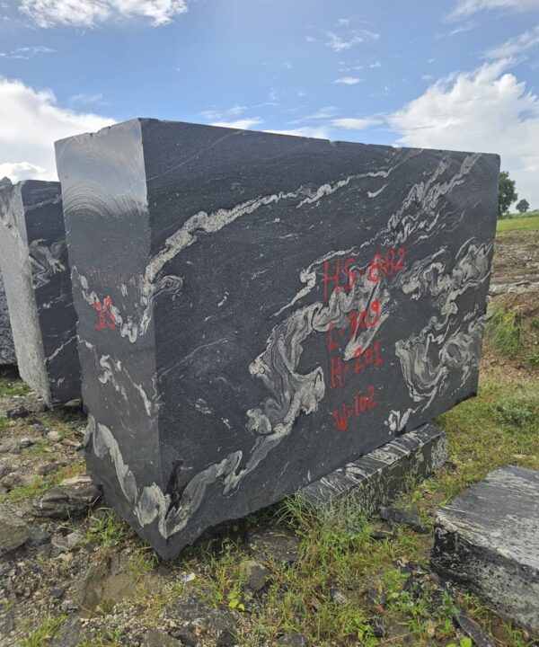 Product Overview: Reliance Titanium Black & Forest Black Granite is a luxurious natural stone celebrated for its striking black background enriched with flowing golden and white veins. Mined from our owned quarry, this granite represents strength, elegance, and timeless beauty — making it a preferred choice for high-end architectural and interior projects across the globe. Each block is a unique creation of nature, offering unmatched character and visual depth. Technical Specifications: Title Reliance Titanium Black & Forest Black Granite Block Stone Type Granite Block Type Gangsaw Block Block Size 300 CM x 180 CM x 180 CM (LXWXH) Color Deep Black with Gold & White Veins Surface Finish Options Wire Saw Cut Density 2960-3000 kg/m3 Compressive Strength 200-250 MPa Water Absorption 0.2%-0.3% Hardness (Mohs) 6 to 7 Porosity Low Origin India Applications Slabs, Countertops, Flooring, Wall Cladding, Interior Key Features: Elegant Aesthetic Appeal: Deep jet-black background enhanced by golden and silver waves — a naturally luxurious look. Superior Strength & Durability: Excellent structural integrity and long-term performance in varied climates. High Polish Retention: Achieves exceptional gloss and mirror-like reflection after finishing. Consistent Texture: Uniform color and grain suitable for large-scale architectural applications. Versatile Application Range: Perfect for multiple interior purposes. Low Maintenance: Resistant to stains, scratches, and moisture, ensuring lasting beauty with minimal upkeep. Export-Grade Blocks: Carefully selected and cut for optimal slab yield and international market standards. Recommended Uses: Kitchen Countertops & Islands Luxury Flooring & Staircases Hotel Lobbies & Reception Areas Wall Cladding & Facades Memorials & Monuments Designer Furniture Tops Why Choose Reliance Titanium Black Granite and Forest Black Granite? Our granite is preferred by export buyers because of: Natural white veins and attractive deep black surface Zero crack, high strength and durability, suitable for projects & reprocessing Consistent Gang Saw block sizes Strict quality checks for each block before shipment Reliable and stable long-term supply Export Capabilities & Payment Terms: We provide smooth, professional export handling with: Payment Options: L/C at sight (Letter of Credit at sight) D/P (Documents Against Payment) T/T advance (if preferred by the buyer) Shipping Documents Provided: Bill of Lading (BL) Commercial Invoice Packing List Certificate of Origin Other documents as per buyer requirements Shipping Price Options: FOB (Indian Port) CNF (any destination port globally) Our logistics team ensures timely loading, documentation, and shipment coordination for a hassle-free experience. About Reliance Mines & Minerals We have a strong presence in the global stone industry, regularly exporting to China, Germany, USA, Oman, and Qatar . Our team is experienced in international trade procedures, ensuring professional communication and smooth cooperation with all partners. We Welcome Your Inquiry If your company is seeking a reliable supplier for premium Titanium black & Forest black granite blocks, we would be pleased to offer quotations, block photos, videos and quarry videos and further details. We look forward to establishing a long-term and successful business relationship with your esteemed company. More About Reliance Titanium Black & Forest Black Granite: Reliance Titanium Black & Forest Black Granite combines natural elegance with engineering excellence. Its bold veins and premium polish bring sophistication to any architectural space, while its robust physical properties ensure durability even in demanding environments. Each block is meticulously extracted and inspected to meet international export quality benchmarks. Reliance Mines & Minerals specializes in the sales and global export of premium granite blocks and slabs. With years of experience in the stone industry, we have established a strong presence in international markets. We are committed to delivering top-quality granite with timely and reliable shipments to major ports worldwide. Our dedicated sales and logistics team is highly skilled in managing export documentation, container loading, and shipping procedures, ensuring a smooth and hassle-free experience for our clients. At the heart of our business is a focus on excellence, professionalism, and customer satisfaction, making us a trusted partner for granite buyers around the globe. 印度 花岗岩 块料 泰坦黑 花岗岩 印度 森林黑 花岗岩 印度 印度 花岗岩 块料, 印度 出口 花岗岩 块, 印度花岗岩原石 中国进口 India granite block Titanium Black granite India Forest Black granite India Granite Blocks Titanium Black Granite Reliance Titanium Black Granite Titanium Black Granite Slabs Polished Titanium Black Granite Bookmatch Titanium Black Granite Titanium Black Granite Exporters India Titanium Black Granite Suppliers Titanium Black Granite Manufacturers Exotic Black Granite with White Veins Deep Black Granite Slabs Mirror Polished Granite Luxury Granite for Interior Walls Natural Stone for Modern Architecture High Gloss Granite Panels Bookmatched Granite Wall Design Black Granite for Hotel Lobby & Flooring Designer Granite Slabs for Projects Indian Granite Exporters Premium Granite from India Granite Slabs for Export Worldwide Granite Supplier Natural Stone Exporter from India Wholesale Granite Supplier Black Granite for Construction & Interiors Architectural Granite Stone Supplier Custom Cut Granite Slabs Export Granite for Wall Cladding Granite for Flooring Granite for Kitchen Countertops Granite for Hotel & Commercial Projects Interior Stone Cladding Luxury Stone for Architects & Designers Black Forest Granite supplier Black Forest Granite manufacturer Black Forest Granite exporter Black Forest Granite quarry Black Forest Granite wholesaler Black Forest Granite seller Buy Black Forest Granite blocks Buy Black Forest Granite slabs Black Forest Granite for flooring Black Forest Granite for countertops Black Forest Granite for wall cladding Black Forest Granite price per sqm Black Forest Granite bulk supplier Black Forest Granite block exporter Black Forest Granite slab manufacturer Black Forest Granite quarry owner Black Forest Granite wholesale price Black Forest Granite large quantity supplier Black Forest Granite custom sizes Black Forest Granite supplier India Black Forest Granite manufacturer India Black Forest Granite exporter India Black Forest Granite quarry India Black Forest Granite supplier [Your City/State] Black Forest Granite international exporter Premium Black Forest Granite supplier Natural Black Forest Granite stone High quality Black Forest Granite slabs Black Forest Granite direct from quarry Black Forest Granite blocks for export Black Forest Granite polished slabs Black granite stone supplier Natural granite stone exporter Indian black granite manufacturer Granite blocks and slabs exporter Dimension stone granite supplier Nebula Wave Granite Stone Manufacturer Export Quality Blocks Supplier Quarry Reliance Mines India Titanium Black Granite Stone Manufacturer Export Quality Blocks Supplier Quarry Reliance Mines India Cosmic Black Granite Stone Manufacturer Export Quality Blocks Supplier Quarry Reliance Mines India Marquina Black Granite Stone Manufacturer Export Quality Blocks Supplier Quarry Reliance Mines India Black Forest Granite Stone Manufacturer Export Quality Blocks Supplier Quarry Reliance Mines India #TitaniumBlackGranite #RelianceGranite #IndianGranite #GraniteExporter #LuxuryGranite #GraniteSupplier #BlackGranite #NaturalStoneIndia #GraniteSlabs #GraniteBookmatch #InteriorDesignStone #ArchitecturalStone #PremiumGranite #GraniteExport #GraniteDesigns #reliancemines #granite #marble #stone #quarry #forestblackgranite
