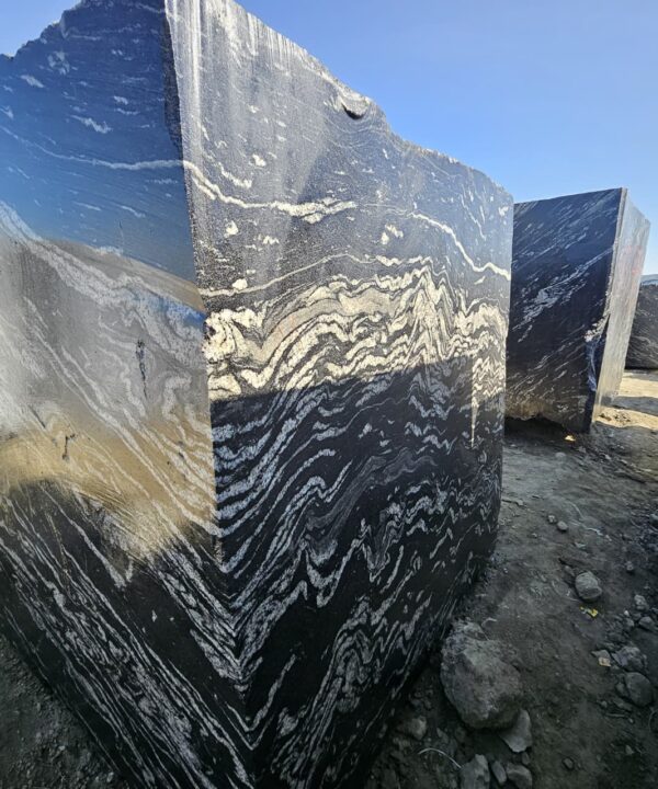 Product Overview: Reliance Titanium Black & Forest Black Granite is a luxurious natural stone celebrated for its striking black background enriched with flowing golden and white veins. Mined from our owned quarry, this granite represents strength, elegance, and timeless beauty — making it a preferred choice for high-end architectural and interior projects across the globe. Each block is a unique creation of nature, offering unmatched character and visual depth. Technical Specifications: Title Reliance Titanium Black & Forest Black Granite Block Stone Type Granite Block Type Gangsaw Block Block Size 300 CM x 180 CM x 180 CM (LXWXH) Color Deep Black with Gold & White Veins Surface Finish Options Wire Saw Cut Density 2960-3000 kg/m3 Compressive Strength 200-250 MPa Water Absorption 0.2%-0.3% Hardness (Mohs) 6 to 7 Porosity Low Origin India Applications Slabs, Countertops, Flooring, Wall Cladding, Interior Key Features: Elegant Aesthetic Appeal: Deep jet-black background enhanced by golden and silver waves — a naturally luxurious look. Superior Strength & Durability: Excellent structural integrity and long-term performance in varied climates. High Polish Retention: Achieves exceptional gloss and mirror-like reflection after finishing. Consistent Texture: Uniform color and grain suitable for large-scale architectural applications. Versatile Application Range: Perfect for multiple interior purposes. Low Maintenance: Resistant to stains, scratches, and moisture, ensuring lasting beauty with minimal upkeep. Export-Grade Blocks: Carefully selected and cut for optimal slab yield and international market standards. Recommended Uses: Kitchen Countertops & Islands Luxury Flooring & Staircases Hotel Lobbies & Reception Areas Wall Cladding & Facades Memorials & Monuments Designer Furniture Tops Why Choose Reliance Titanium Black Granite and Forest Black Granite? Our granite is preferred by export buyers because of: Natural white veins and attractive deep black surface Zero crack, high strength and durability, suitable for projects & reprocessing Consistent Gang Saw block sizes Strict quality checks for each block before shipment Reliable and stable long-term supply Export Capabilities & Payment Terms: We provide smooth, professional export handling with: Payment Options: L/C at sight (Letter of Credit at sight) D/P (Documents Against Payment) T/T advance (if preferred by the buyer) Shipping Documents Provided: Bill of Lading (BL) Commercial Invoice Packing List Certificate of Origin Other documents as per buyer requirements Shipping Price Options: FOB (Indian Port) CNF (any destination port globally) Our logistics team ensures timely loading, documentation, and shipment coordination for a hassle-free experience. About Reliance Mines & Minerals We have a strong presence in the global stone industry, regularly exporting to China, Germany, USA, Oman, and Qatar . Our team is experienced in international trade procedures, ensuring professional communication and smooth cooperation with all partners. We Welcome Your Inquiry If your company is seeking a reliable supplier for premium Titanium black & Forest black granite blocks, we would be pleased to offer quotations, block photos, videos and quarry videos and further details. We look forward to establishing a long-term and successful business relationship with your esteemed company. More About Reliance Titanium Black & Forest Black Granite: Reliance Titanium Black & Forest Black Granite combines natural elegance with engineering excellence. Its bold veins and premium polish bring sophistication to any architectural space, while its robust physical properties ensure durability even in demanding environments. Each block is meticulously extracted and inspected to meet international export quality benchmarks. Reliance Mines & Minerals specializes in the sales and global export of premium granite blocks and slabs. With years of experience in the stone industry, we have established a strong presence in international markets. We are committed to delivering top-quality granite with timely and reliable shipments to major ports worldwide. Our dedicated sales and logistics team is highly skilled in managing export documentation, container loading, and shipping procedures, ensuring a smooth and hassle-free experience for our clients. At the heart of our business is a focus on excellence, professionalism, and customer satisfaction, making us a trusted partner for granite buyers around the globe. 印度 花岗岩 块料 泰坦黑 花岗岩 印度 森林黑 花岗岩 印度 印度 花岗岩 块料, 印度 出口 花岗岩 块, 印度花岗岩原石 中国进口 India granite block Titanium Black granite India Forest Black granite India Granite Blocks Titanium Black Granite Reliance Titanium Black Granite Titanium Black Granite Slabs Polished Titanium Black Granite Bookmatch Titanium Black Granite Titanium Black Granite Exporters India Titanium Black Granite Suppliers Titanium Black Granite Manufacturers Exotic Black Granite with White Veins Deep Black Granite Slabs Mirror Polished Granite Luxury Granite for Interior Walls Natural Stone for Modern Architecture High Gloss Granite Panels Bookmatched Granite Wall Design Black Granite for Hotel Lobby & Flooring Designer Granite Slabs for Projects Indian Granite Exporters Premium Granite from India Granite Slabs for Export Worldwide Granite Supplier Natural Stone Exporter from India Wholesale Granite Supplier Black Granite for Construction & Interiors Architectural Granite Stone Supplier Custom Cut Granite Slabs Export Granite for Wall Cladding Granite for Flooring Granite for Kitchen Countertops Granite for Hotel & Commercial Projects Interior Stone Cladding Luxury Stone for Architects & Designers Black Forest Granite supplier Black Forest Granite manufacturer Black Forest Granite exporter Black Forest Granite quarry Black Forest Granite wholesaler Black Forest Granite seller Buy Black Forest Granite blocks Buy Black Forest Granite slabs Black Forest Granite for flooring Black Forest Granite for countertops Black Forest Granite for wall cladding Black Forest Granite price per sqm Black Forest Granite bulk supplier Black Forest Granite block exporter Black Forest Granite slab manufacturer Black Forest Granite quarry owner Black Forest Granite wholesale price Black Forest Granite large quantity supplier Black Forest Granite custom sizes Black Forest Granite supplier India Black Forest Granite manufacturer India Black Forest Granite exporter India Black Forest Granite quarry India Black Forest Granite supplier [Your City/State] Black Forest Granite international exporter Premium Black Forest Granite supplier Natural Black Forest Granite stone High quality Black Forest Granite slabs Black Forest Granite direct from quarry Black Forest Granite blocks for export Black Forest Granite polished slabs Black granite stone supplier Natural granite stone exporter Indian black granite manufacturer Granite blocks and slabs exporter Dimension stone granite supplier Nebula Wave Granite Stone Manufacturer Export Quality Blocks Supplier Quarry Reliance Mines India Titanium Black Granite Stone Manufacturer Export Quality Blocks Supplier Quarry Reliance Mines India Cosmic Black Granite Stone Manufacturer Export Quality Blocks Supplier Quarry Reliance Mines India Marquina Black Granite Stone Manufacturer Export Quality Blocks Supplier Quarry Reliance Mines India Black Forest Granite Stone Manufacturer Export Quality Blocks Supplier Quarry Reliance Mines India #TitaniumBlackGranite #RelianceGranite #IndianGranite #GraniteExporter #LuxuryGranite #GraniteSupplier #BlackGranite #NaturalStoneIndia #GraniteSlabs #GraniteBookmatch #InteriorDesignStone #ArchitecturalStone #PremiumGranite #GraniteExport #GraniteDesigns #reliancemines #granite #marble #stone #quarry #forestblackgranite