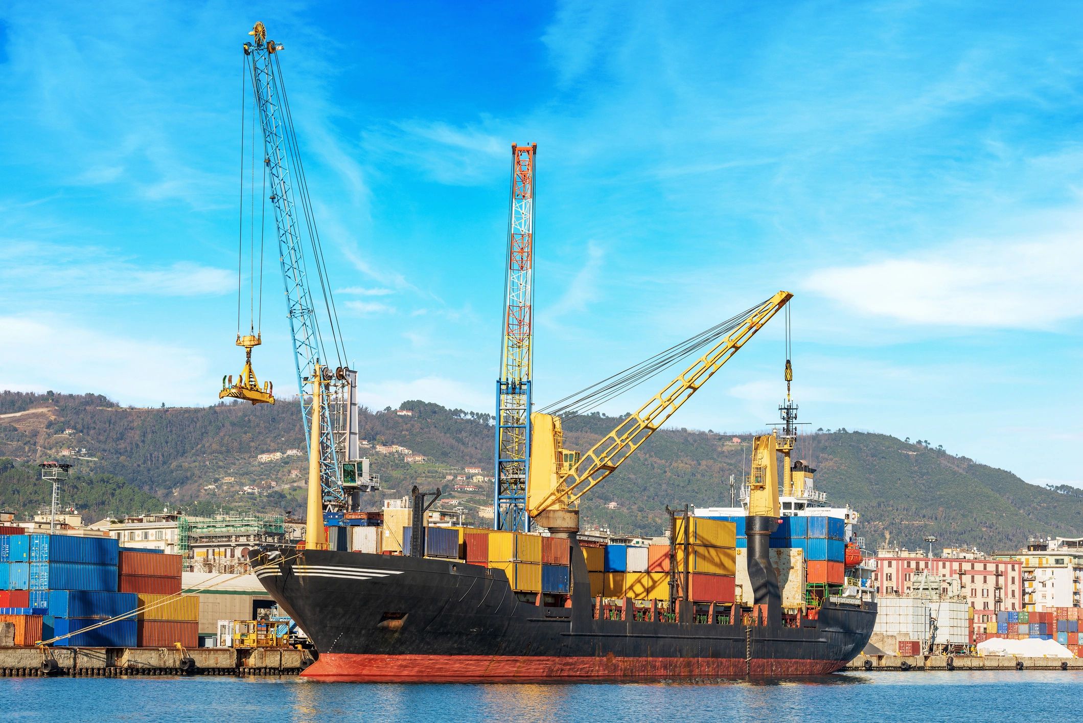 Container ship and cranes representing global granite export logistics