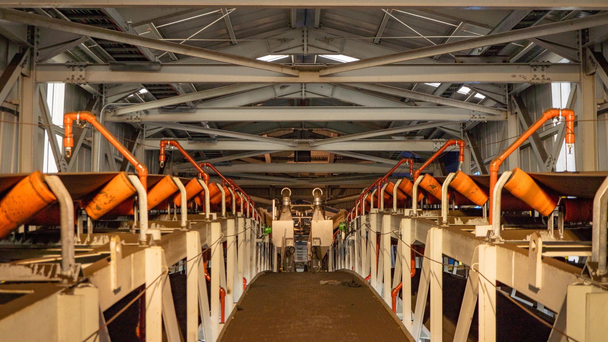 Conveyor system inside industrial processing facility